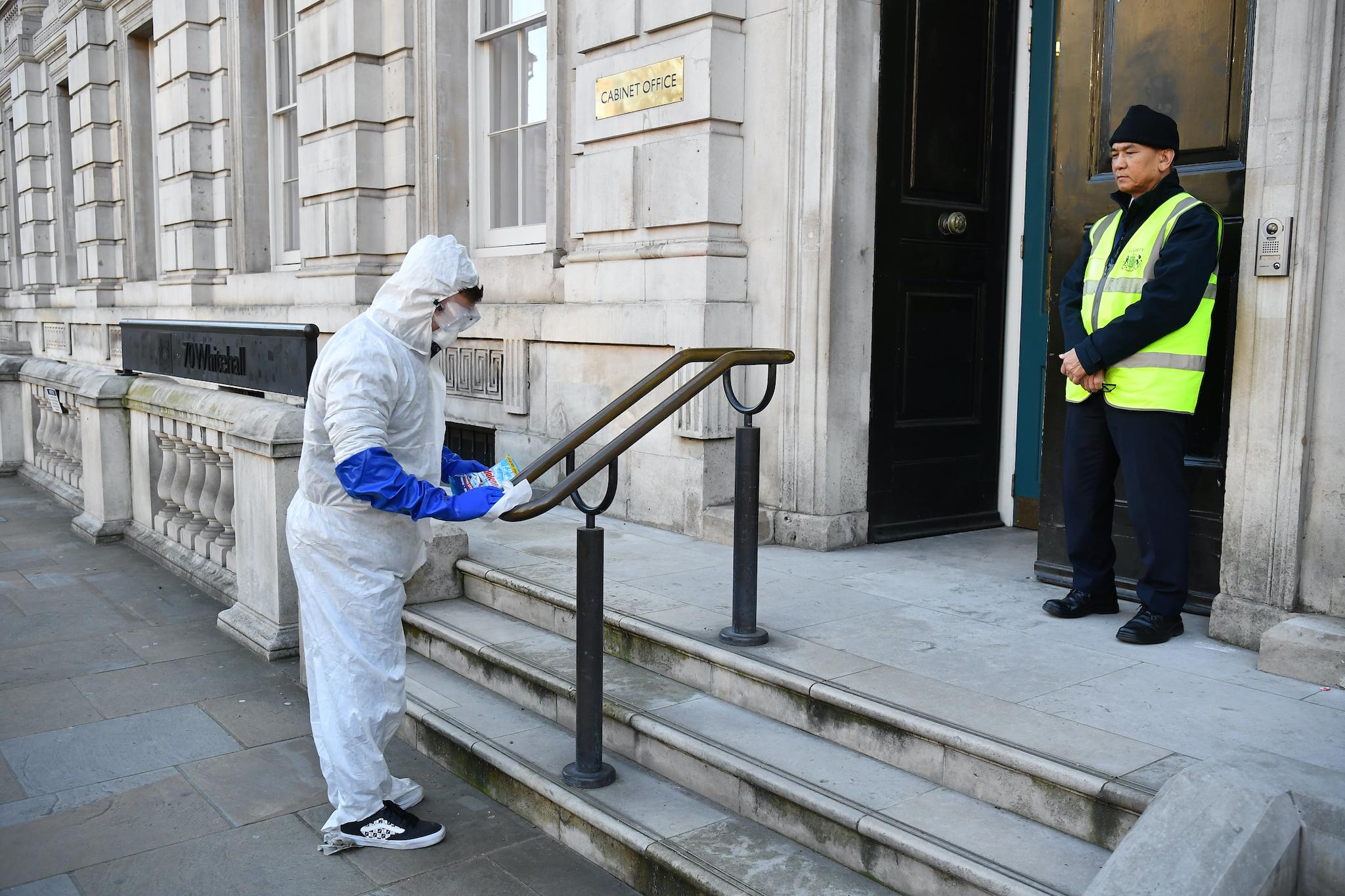 kids create a tiktok video in fake hazmat suits outside the Cabinet Office after a COBRA meeting