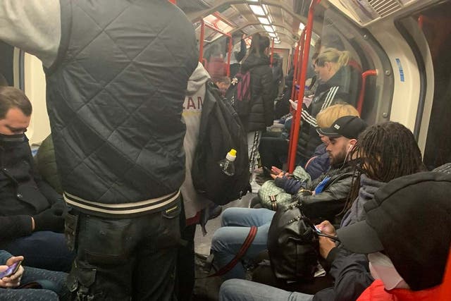 Handout photo taken with permission from the Twitter feed of @ajadmiah2 showing a carriage on the Central Line packed with commuters