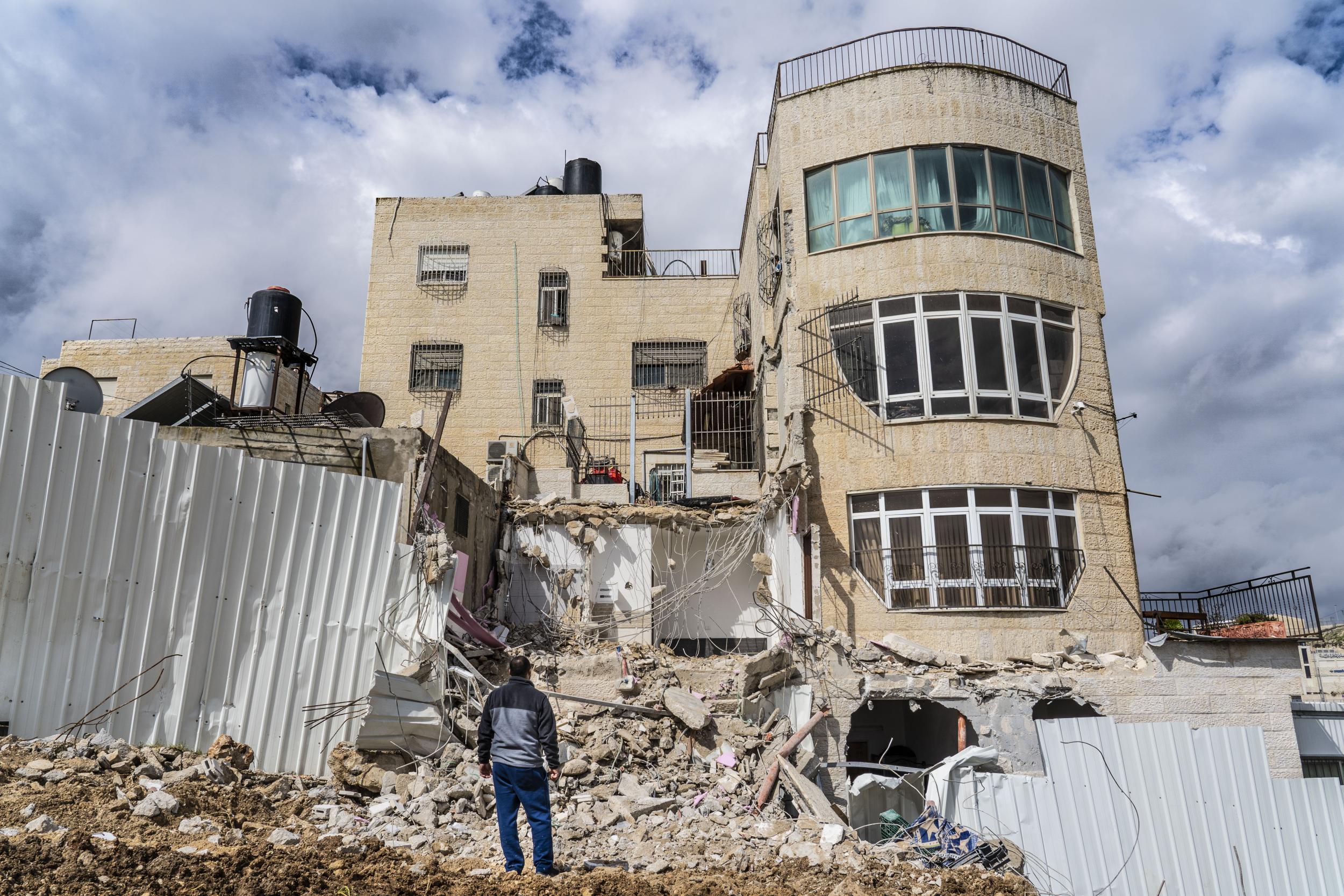 Mohamed Bashiti, 26, stands by the destroyed remains of his home in East Jerusalem