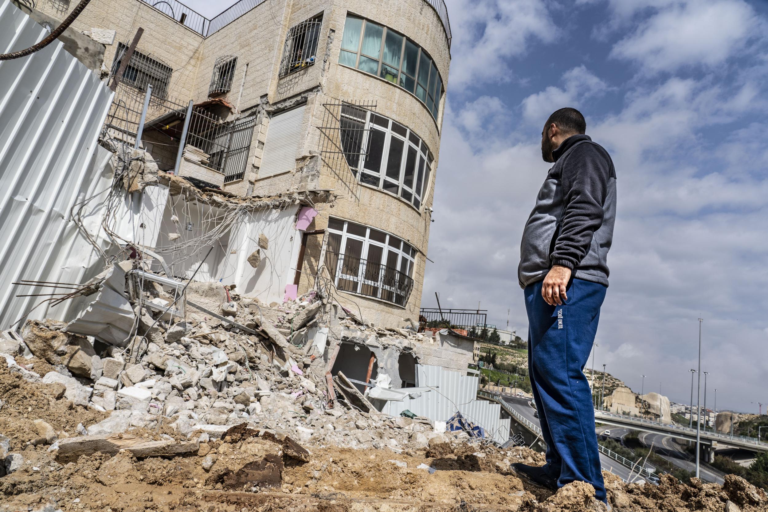 Mohamed stands in front of what was supposed to be his home with his new bride in East Jerusalem