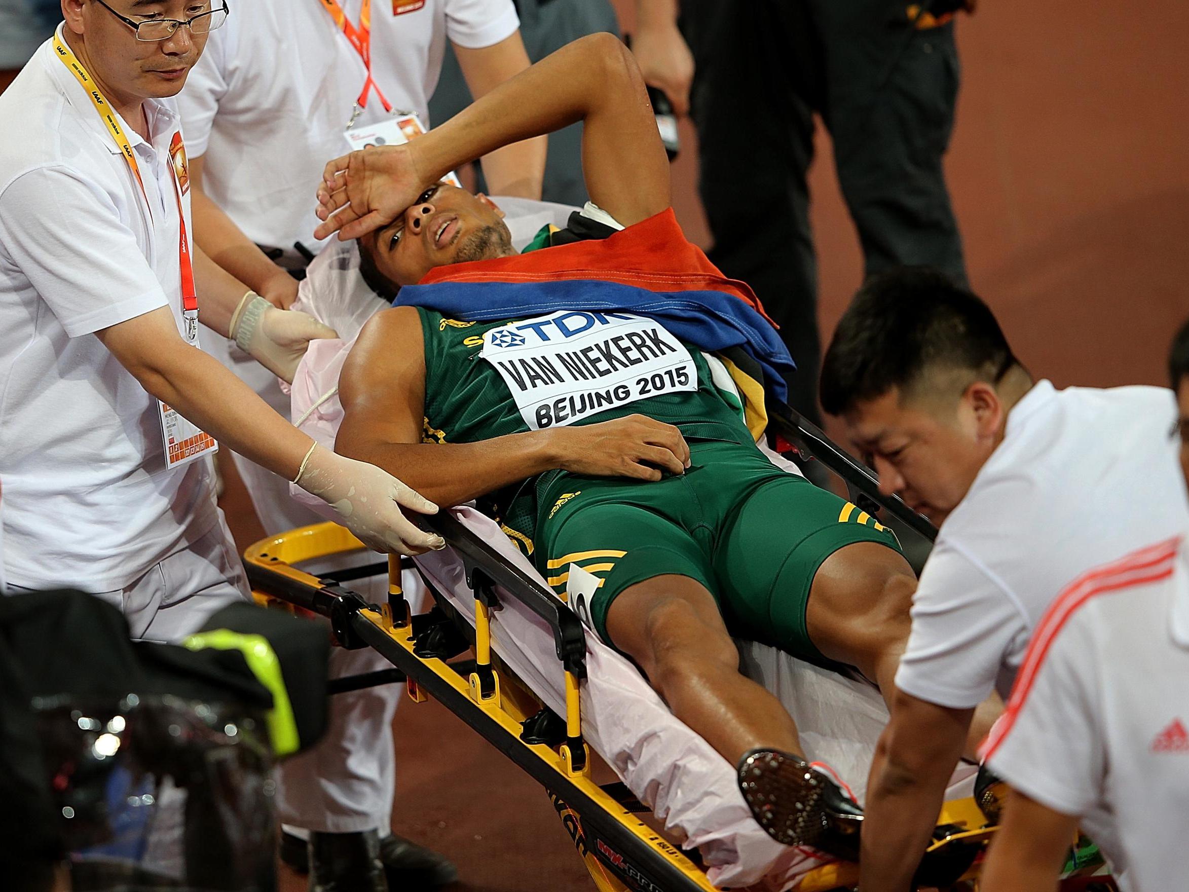 Wayde van Niekerk is wheeled off the track on a stretcher after winning 400m gold at the 2015 World Championships