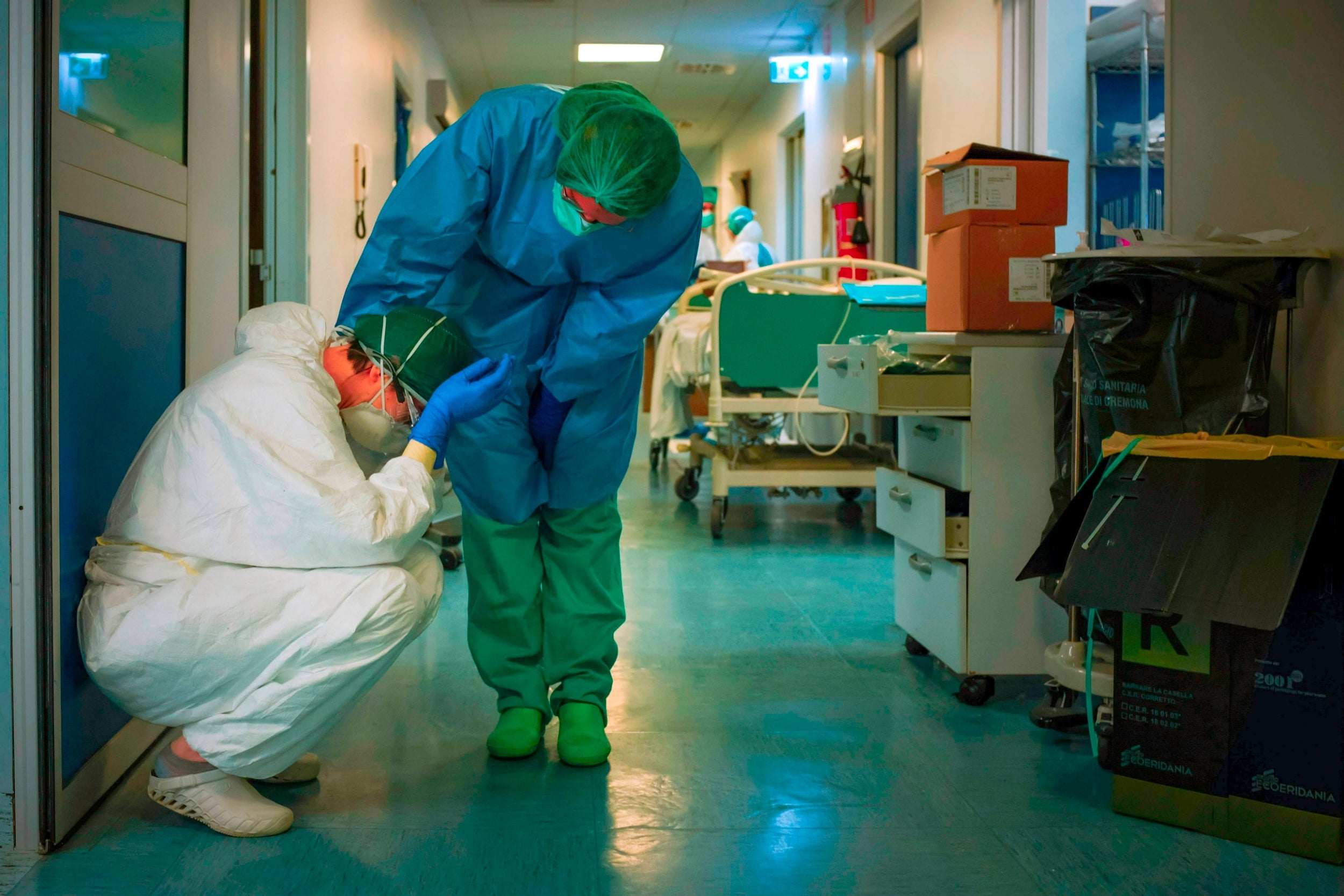 A nurse comforts another as they change shifts at Cremona hospital, south of Milan