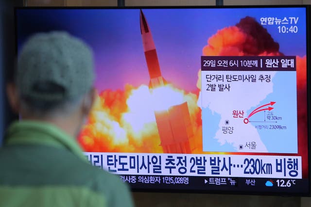 A commuter at a Seoul railway station watches the missile launch on Sunday