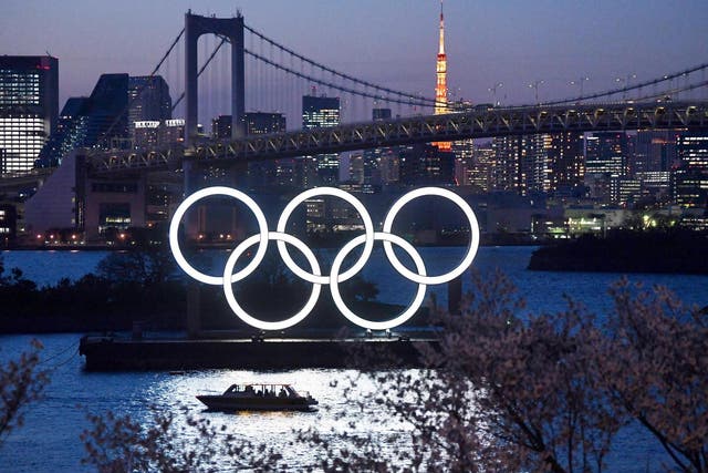 A boat sails past the Olympic rings in Tokyo