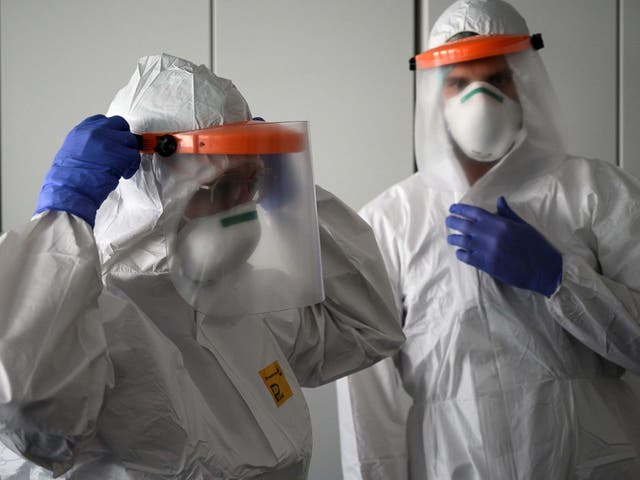 Nurses put on their protective equipment before starting work in the intensive care unit at the new Covid-19 Hospital in Verduno, Northwestern Italy