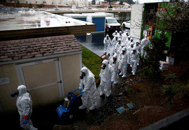 Workers begin a third day of cleaning at the Life Care Centre of Kirkland, a care facility near Seattle, which became one of the deadliest coronavirus outbreak zones in the US