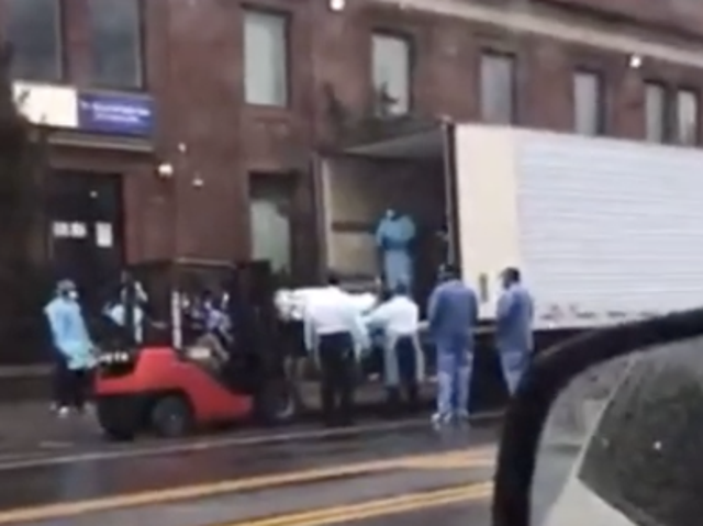 Workers load bodies into a truck of coronavirus victims in New York City. Youtube / Zay Miyagi