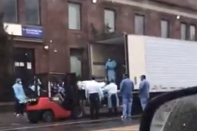 Workers load bodies into a truck of coronavirus victims in New York City. Youtube / Zay Miyagi