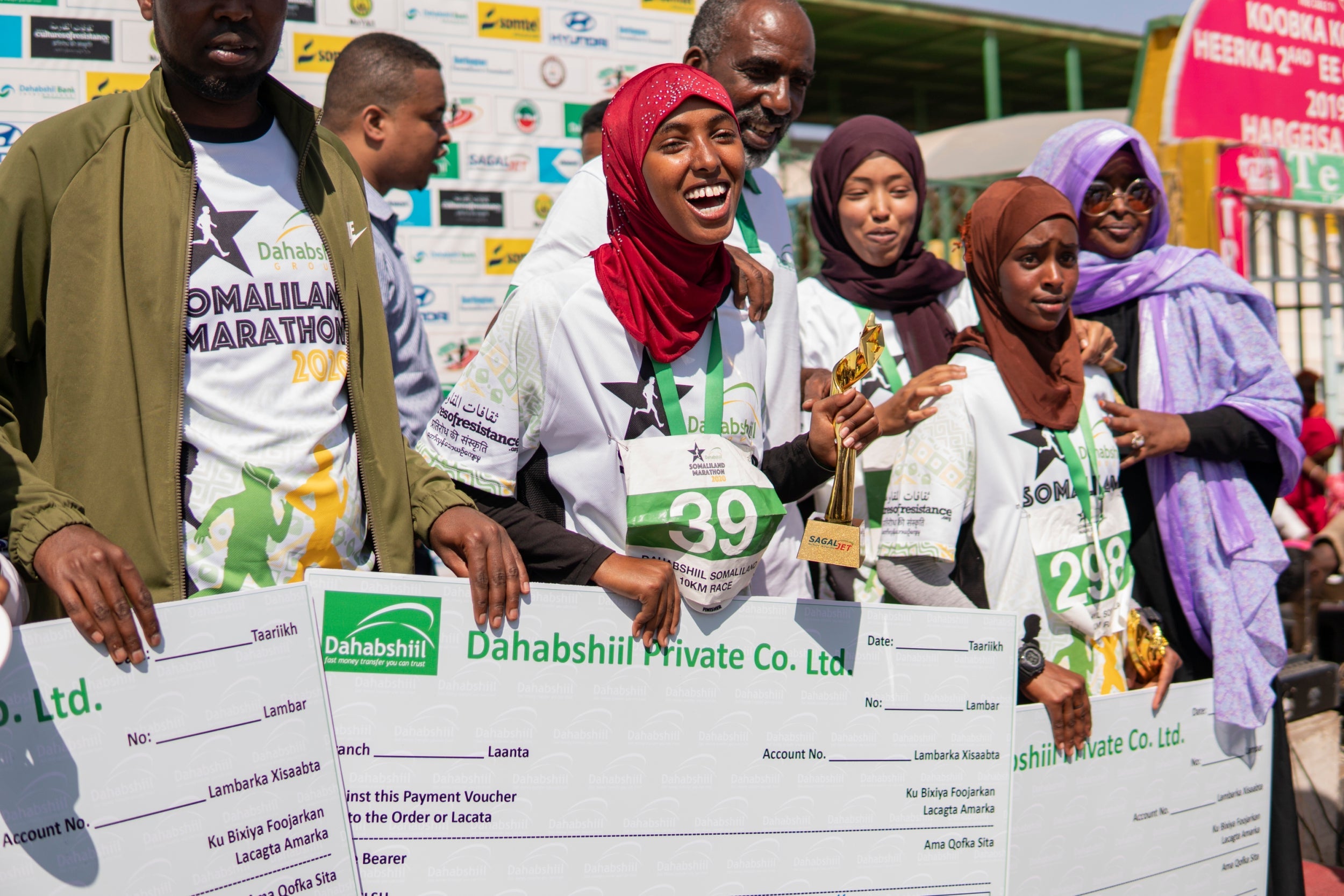 Eido Kush Arab (39), who came in third, celebrates alongside winner Hana Mukhtaar Abdilllahi (298)