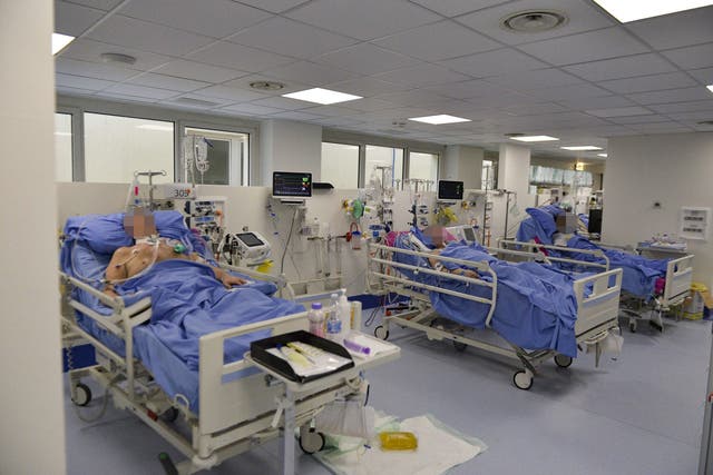 Medical personel and patients at a newly set up intensive care unit for the treatment of coronavirus in Brescia, Italy