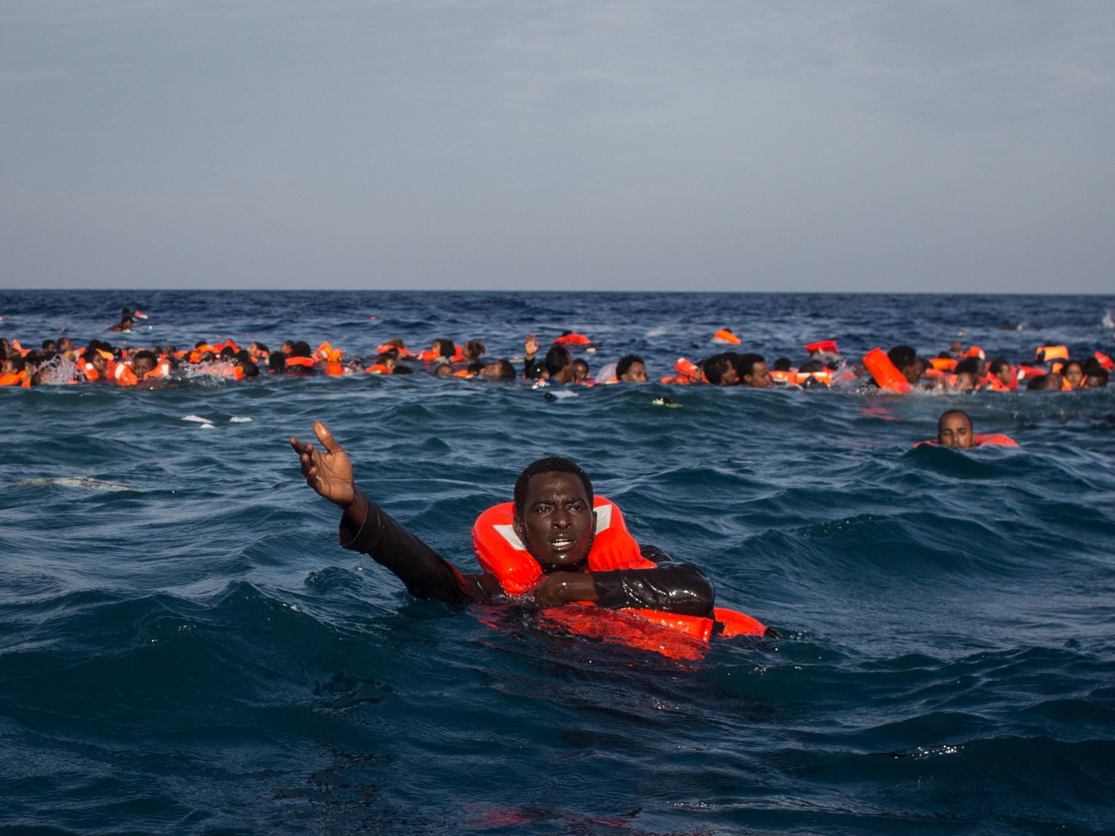 Refugees and migrants swimming and shouting for help from crew members from the Migrant Offshore Aid Station's Phoenix vessel off the coast of Italy, 24 May, 2017