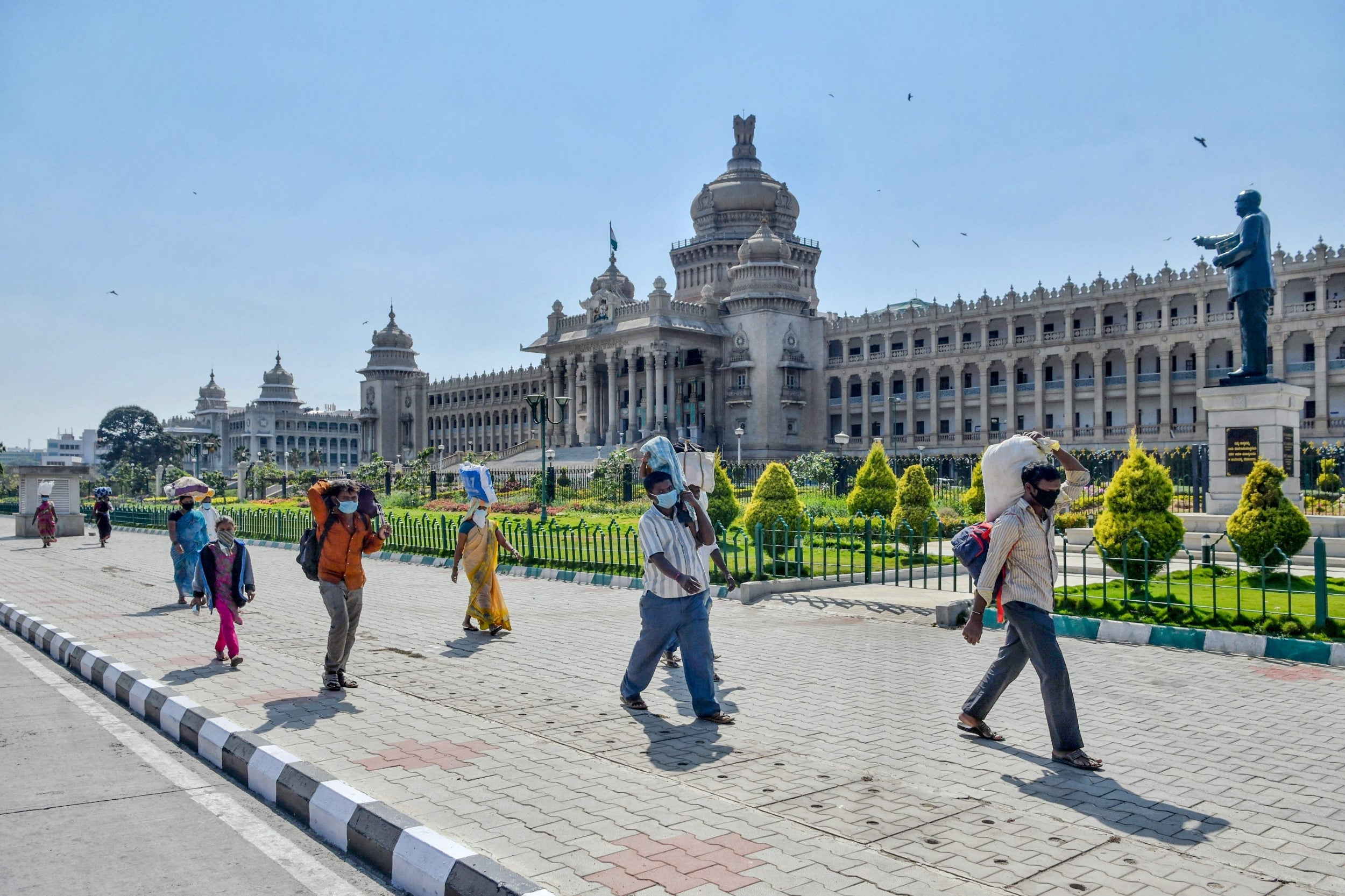 Daily wage labourers and their families leave the city for their hometown in Bangalore on Tuesday