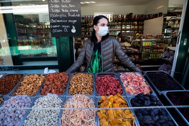 A vendor wearing a protective face mask waits for customers at "Naschmarkt" market in Vienna