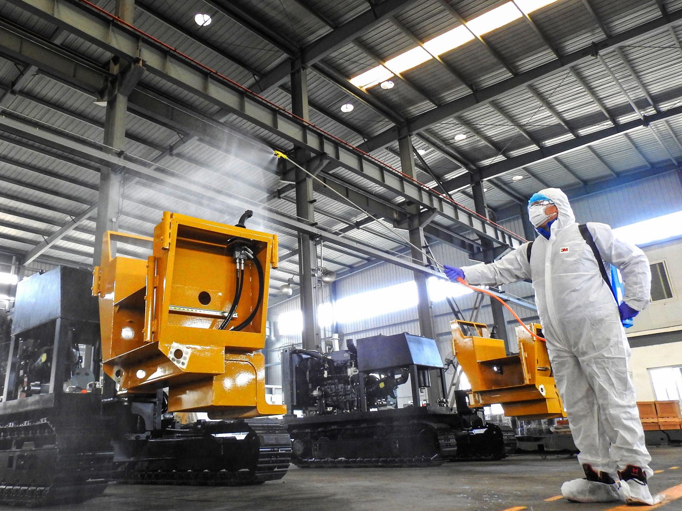 A worker disinfects machines at a factory in Lianyungang in China's eastern Jiangsu province