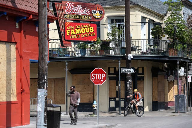 Closed businesses board up windows in the French Quarter in New Orleans, which has become an epicentre for coronavirus with one of the highest per capita death tolls.
