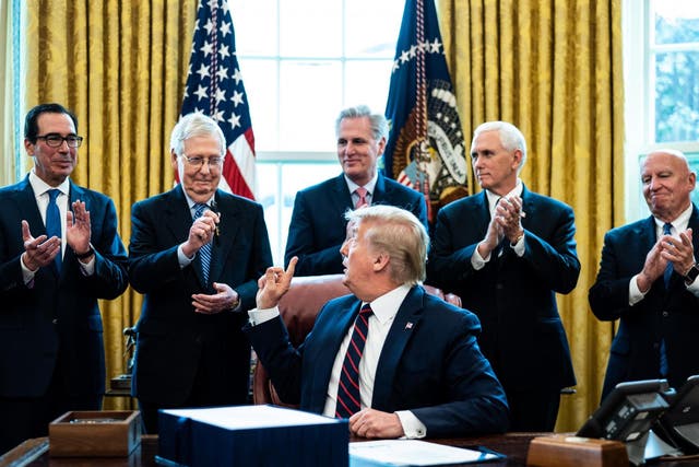 President Donald Trump signs the stimulus bill