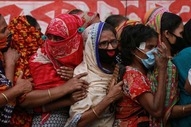 Poor people queue to collect aid during the nationwide lockdown as a preventive measure against the COVID-19 coronavirus outbreak in Dhaka, Bangladesh on 1 April 2020.
