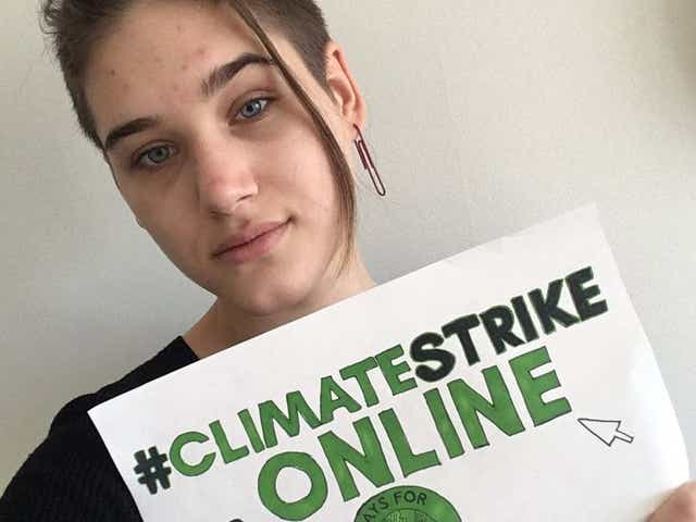 Isabelle Axelsson, one of hundreds of young demonstrators posting photos of themselves online using the hashtag #ClimateStrikeOnline, after Greta Thunberg encouraged youngsters to take their protests to Twitter rather than the streets amid the coronavirus outbreak.