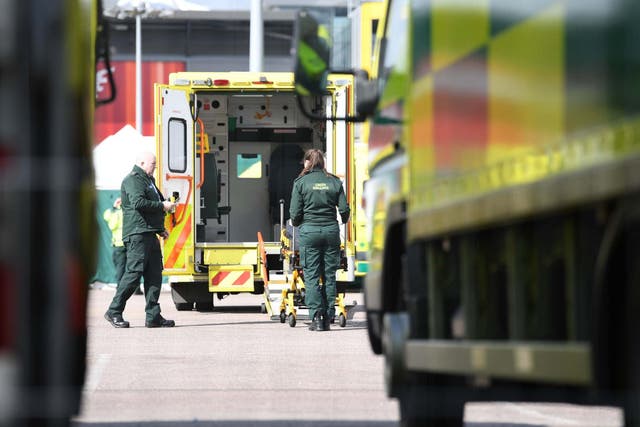 Paramedics preparing an ambulance at the ExCel centre in London which is being made into a temporary NHS Nightingale hospital during the coronavirus outbreak