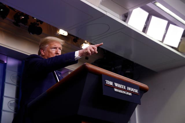 Donald Trump gestures towards reporters as he speaks at a White House briefing on the coronavirus pandemic