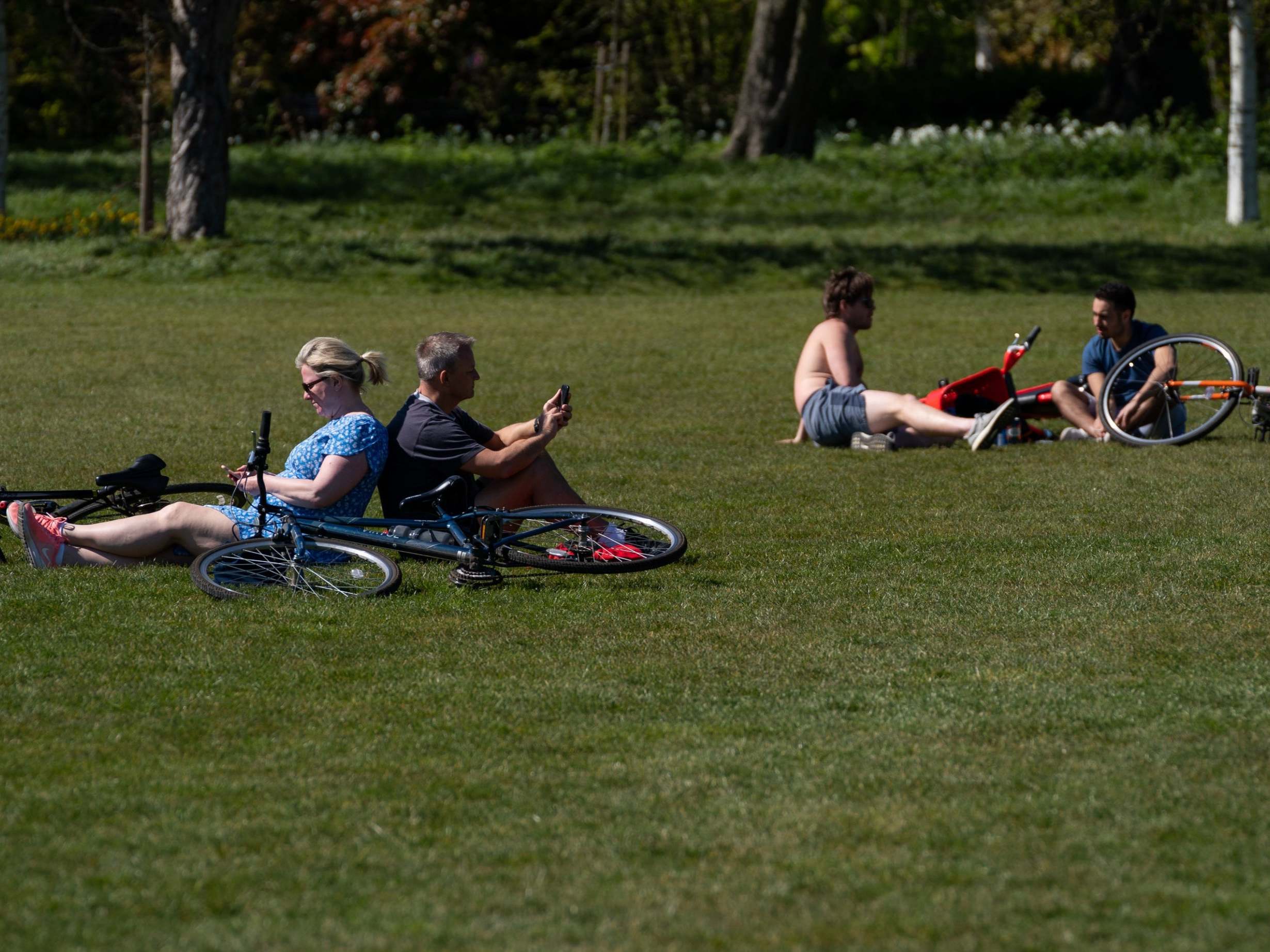 Members of the public relax in the sun despite repeated warnings not to