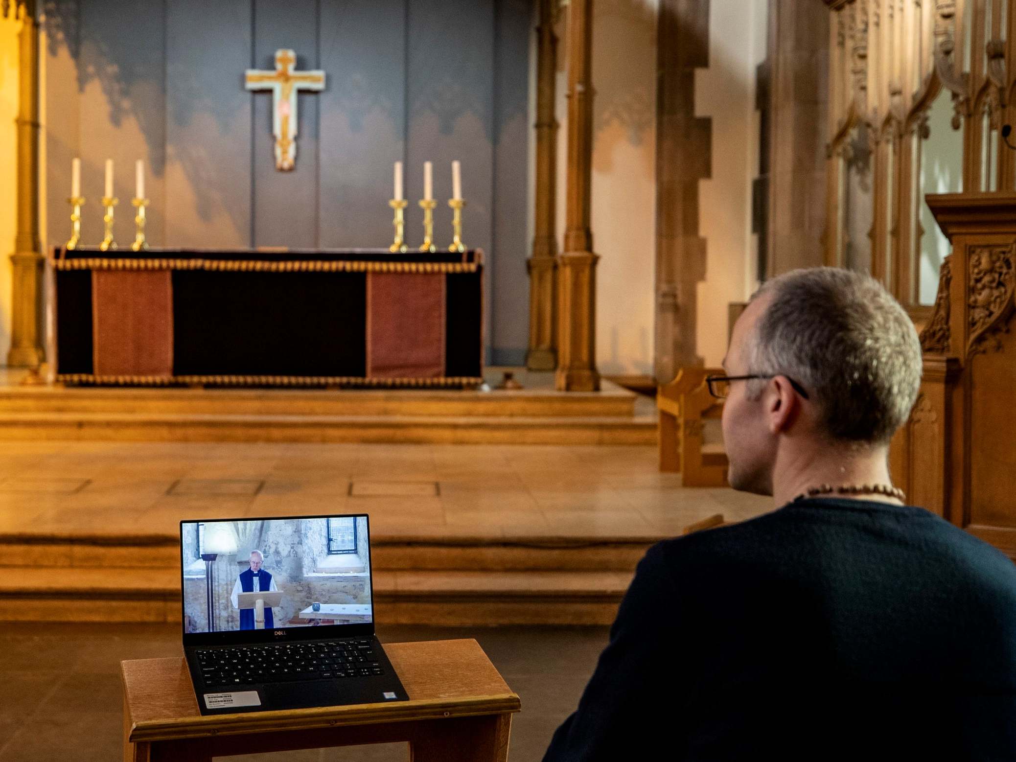 A church parishioner watches a laptop inside Liverpool Parish Church (Our Lady and St Nicholas) in Liverpool