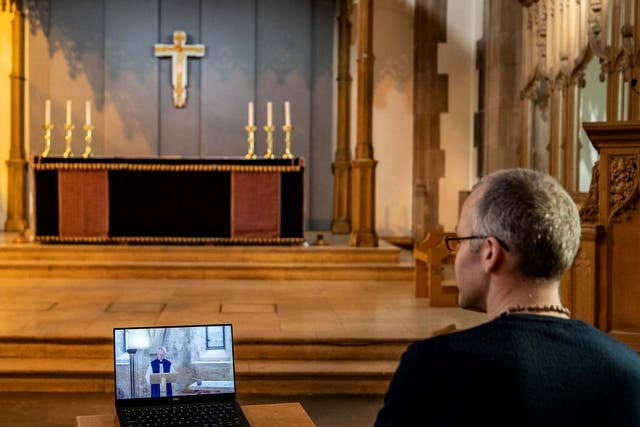 A church parishioner watches a laptop inside Liverpool Parish Church (Our Lady and St Nicholas) in Liverpool