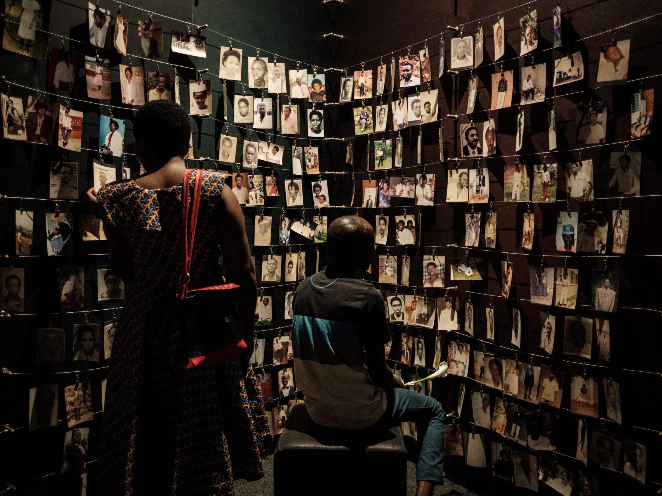 Visitors look at victims' portraits at the Kigali Genocide Memorial in Rwanda