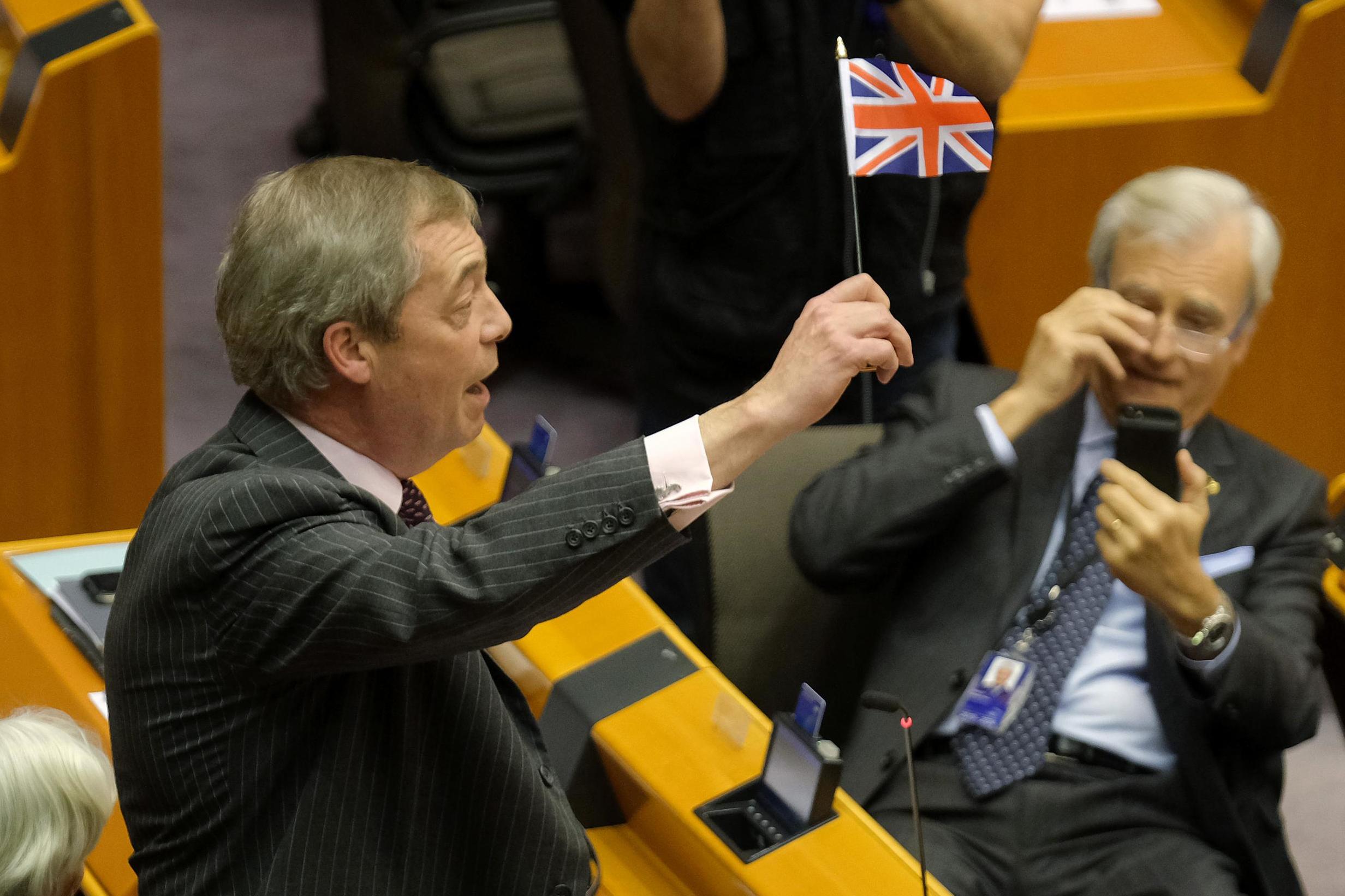 Farage waves a British flag while speaking at a session of the European parliament in which it is to approve the Brexit deal in January 2020 (Getty)