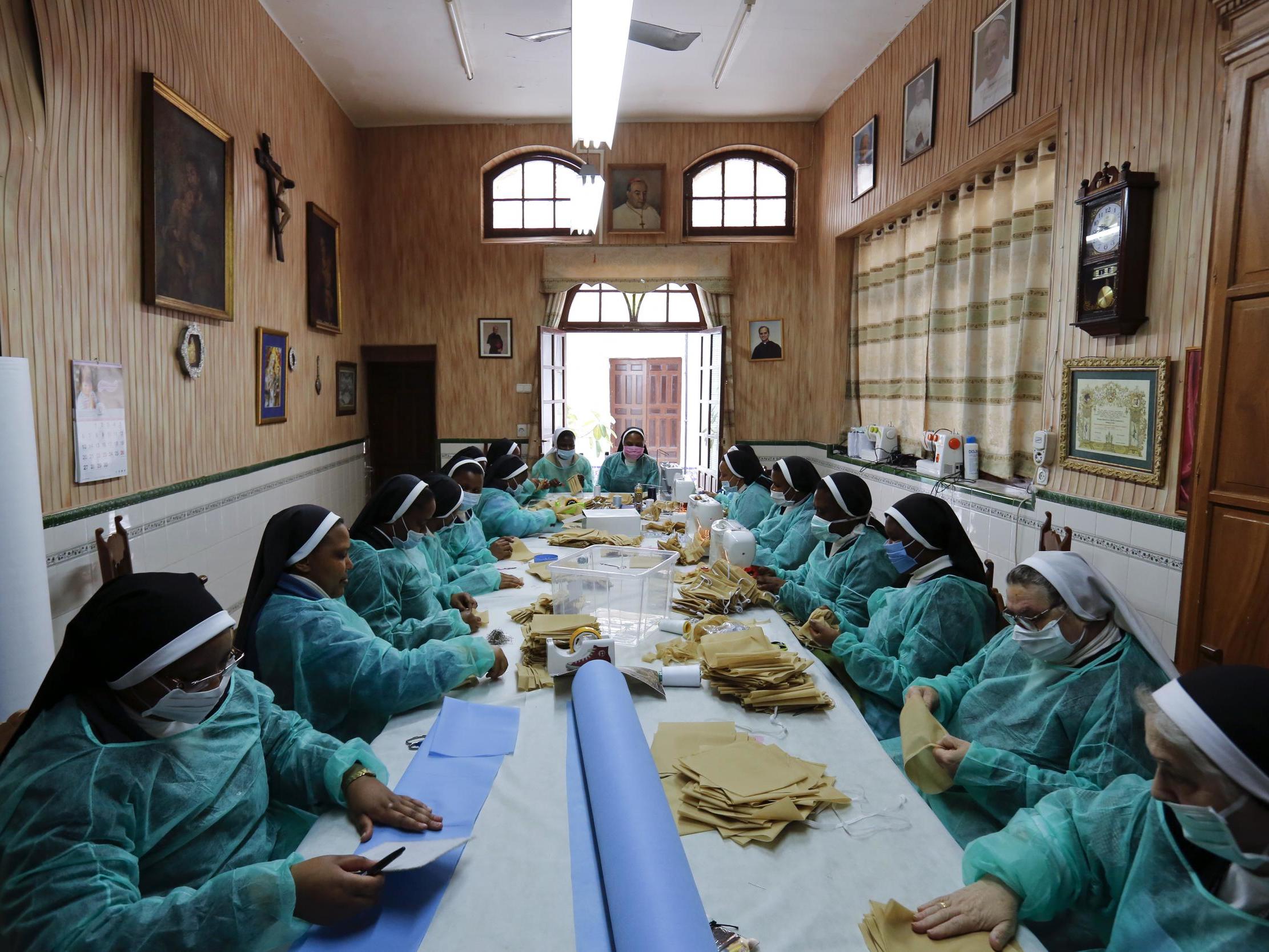 Nuns of the San Leandro convent in Seville make face masks and health coats to help with the national effort in fighting coronavirus