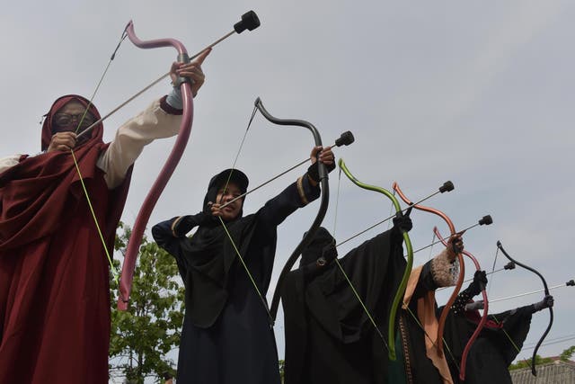 Indonesian Muslim women participate in an archery lesson in Bekasi