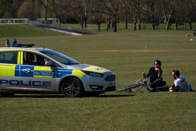 Police move on sunbathers in Regents Park on 5 April as the lockdown continues
