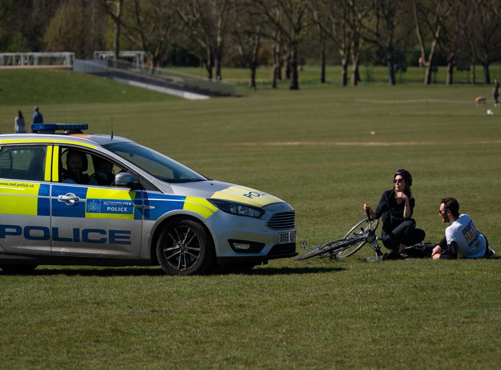 Police move on sunbathers in Regents Park on 5 April as the lockdown continues