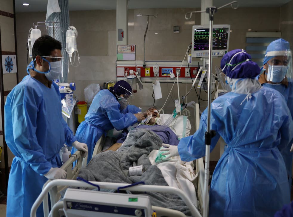 Nurses wearing protective suits look after a patient with coronavirus in Daneshvari Hospital, in Tehran, Iran