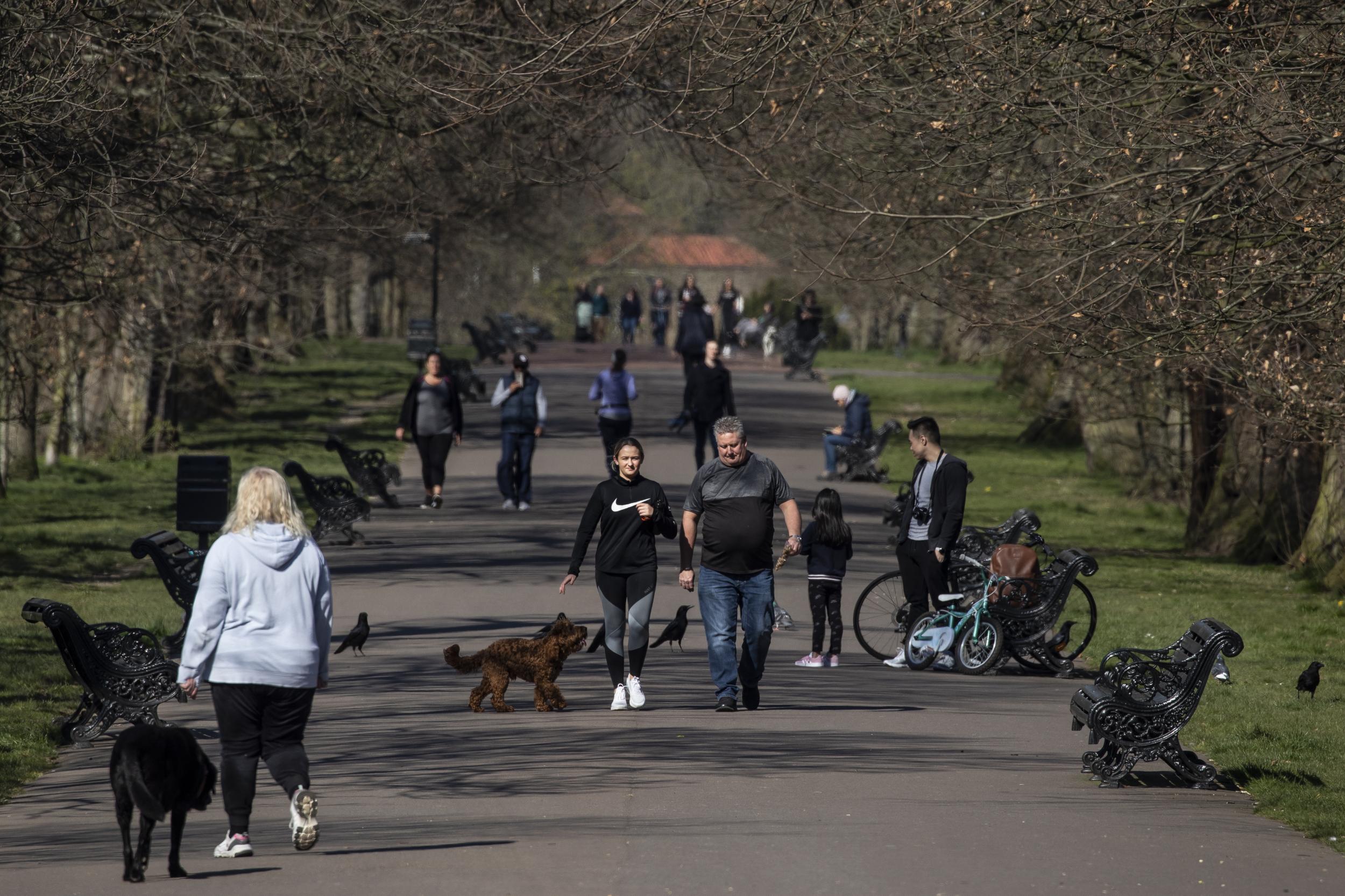 People walk through Greenwich Park on 25 March after Boris Johnson announced strict lockdown measures (Getty)