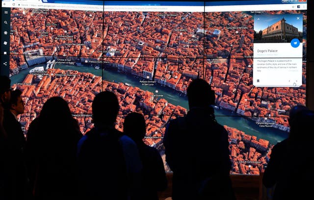 A person looks at a Google Earth map of Venice, Italy on a screen as Google Earth unveils the revamped version of the application April 18, 2017 at a event at New York's Whitney Museum of Art