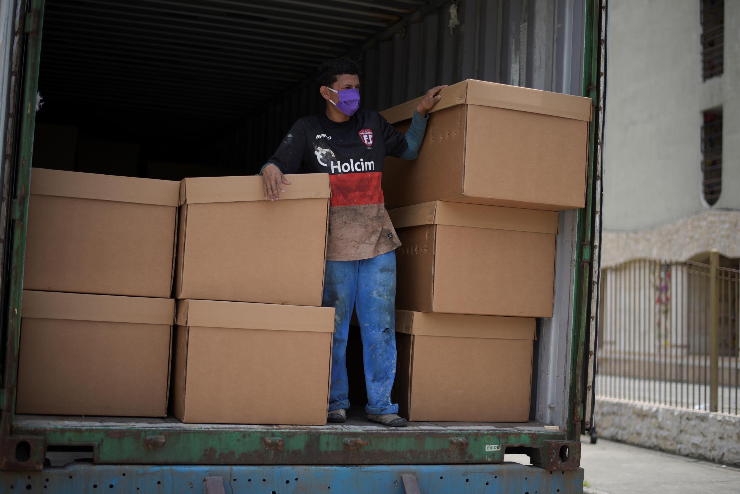 Empty cardboard boxes are piled in a truck outside a cemetery in Guayaquil, as a shortage of coffins begins to bite (Reuters)