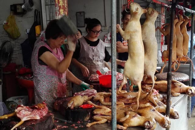 Vendors cut up dog meat at a market in Yulin, home to an annual dog meat festival