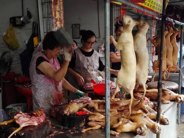 Vendors cut up dog meat at a market in Yulin, home to an annual dog meat festival