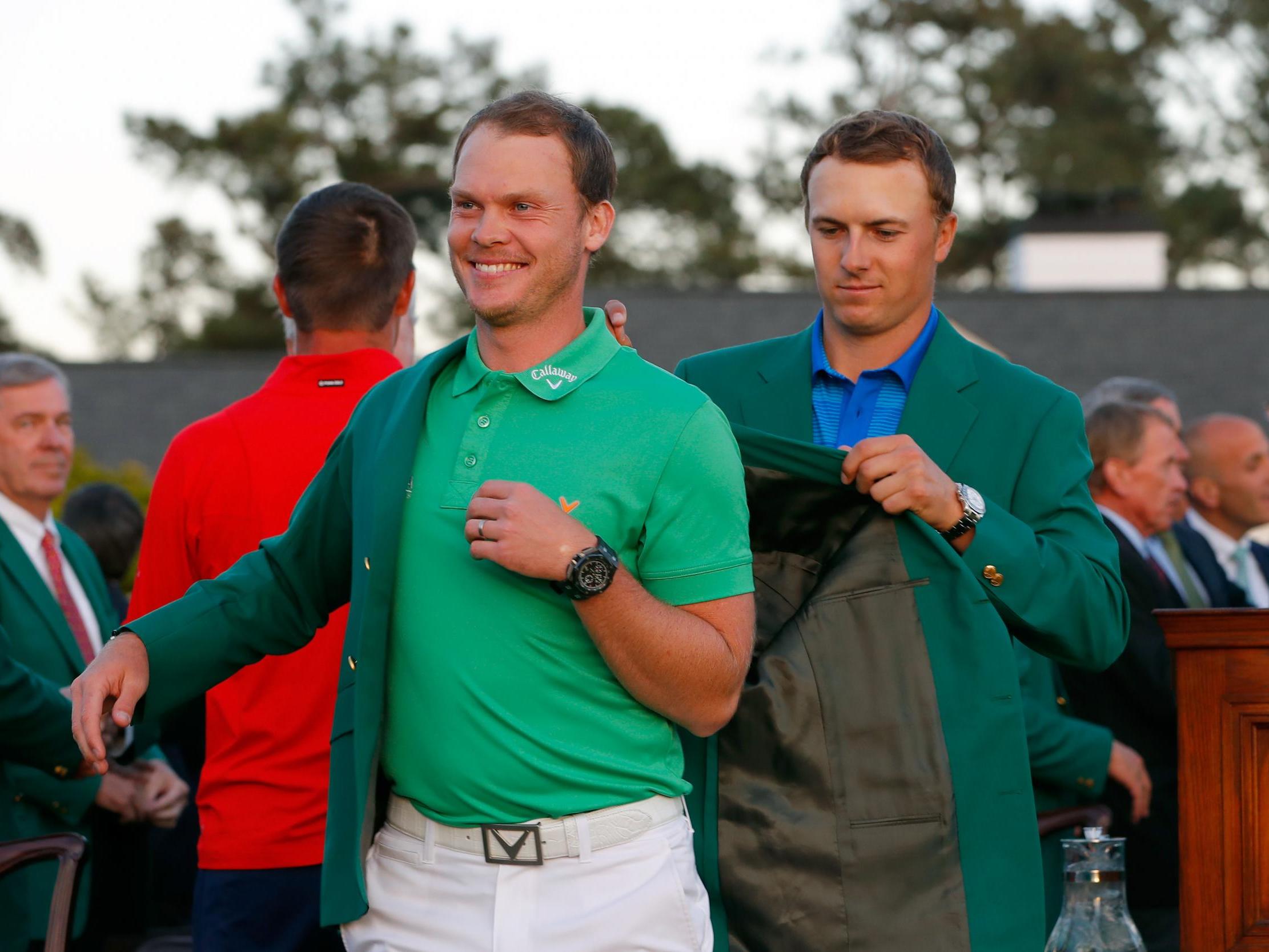 Danny Willett receives the Green Jacket from Jordan Spieth in 2016