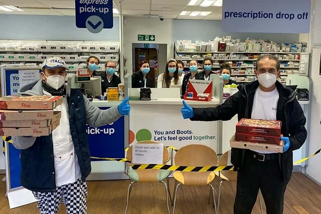 Workers from Di Vitos Chip Shop in Hamilton, South Lanarkshire deliver pizzas to their local chemist