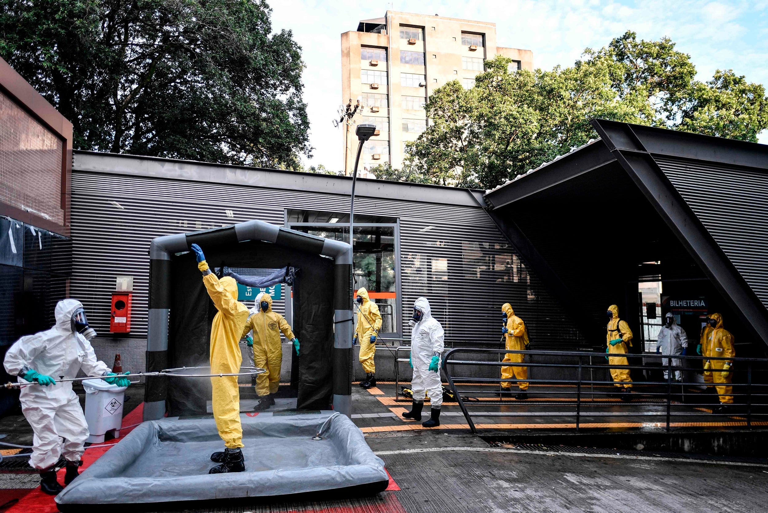 Brazil’s military, firefighters and civil defense members disinfect each other after cleaning in Belo Horizonte, Brazil, on April 9, 2020, to fight the spread of the novel coronavirus (Photo by DOUGLAS MAGNO/AFP via Getty Images)