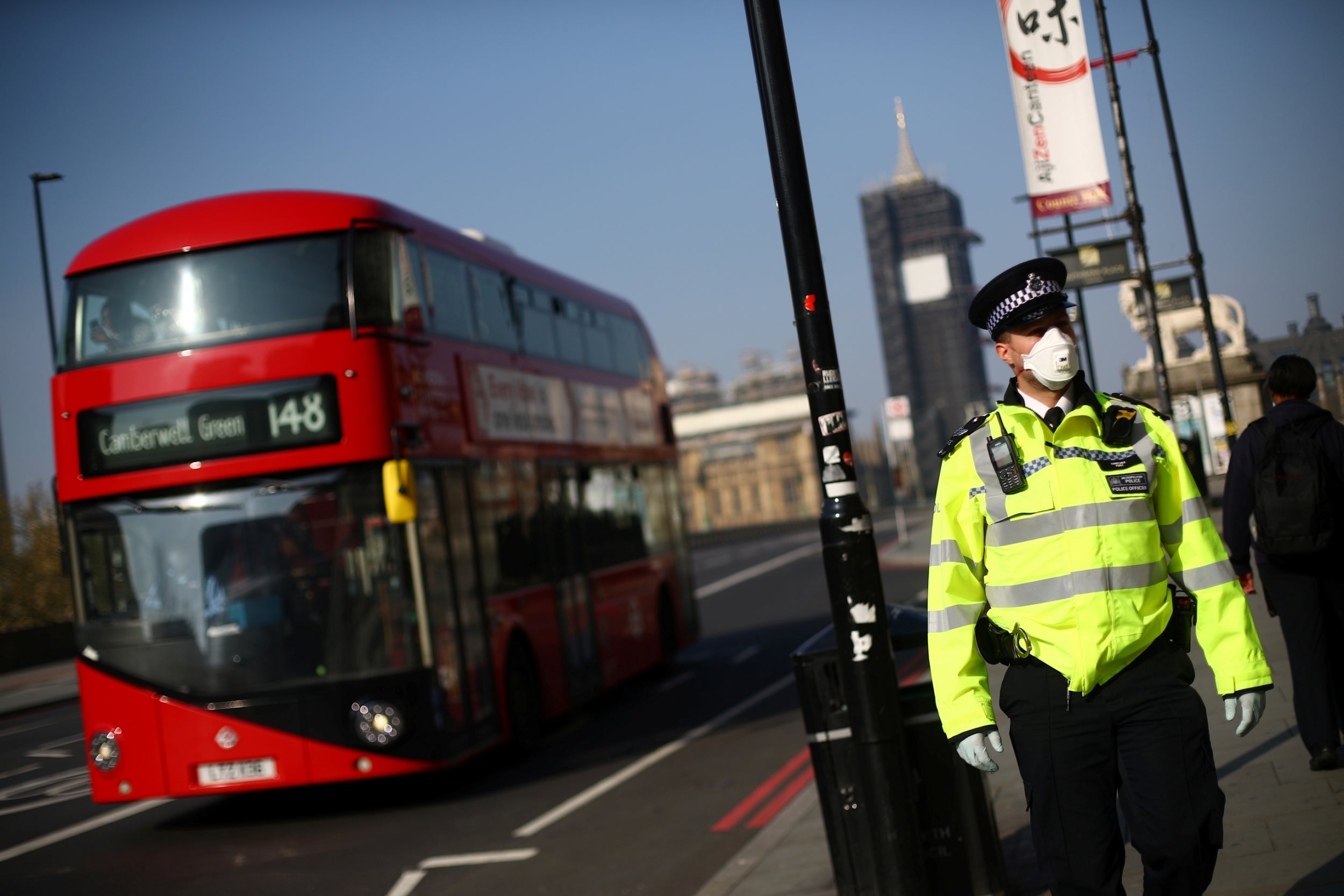 A police officer wears a protective face mask in Westminster yesterday