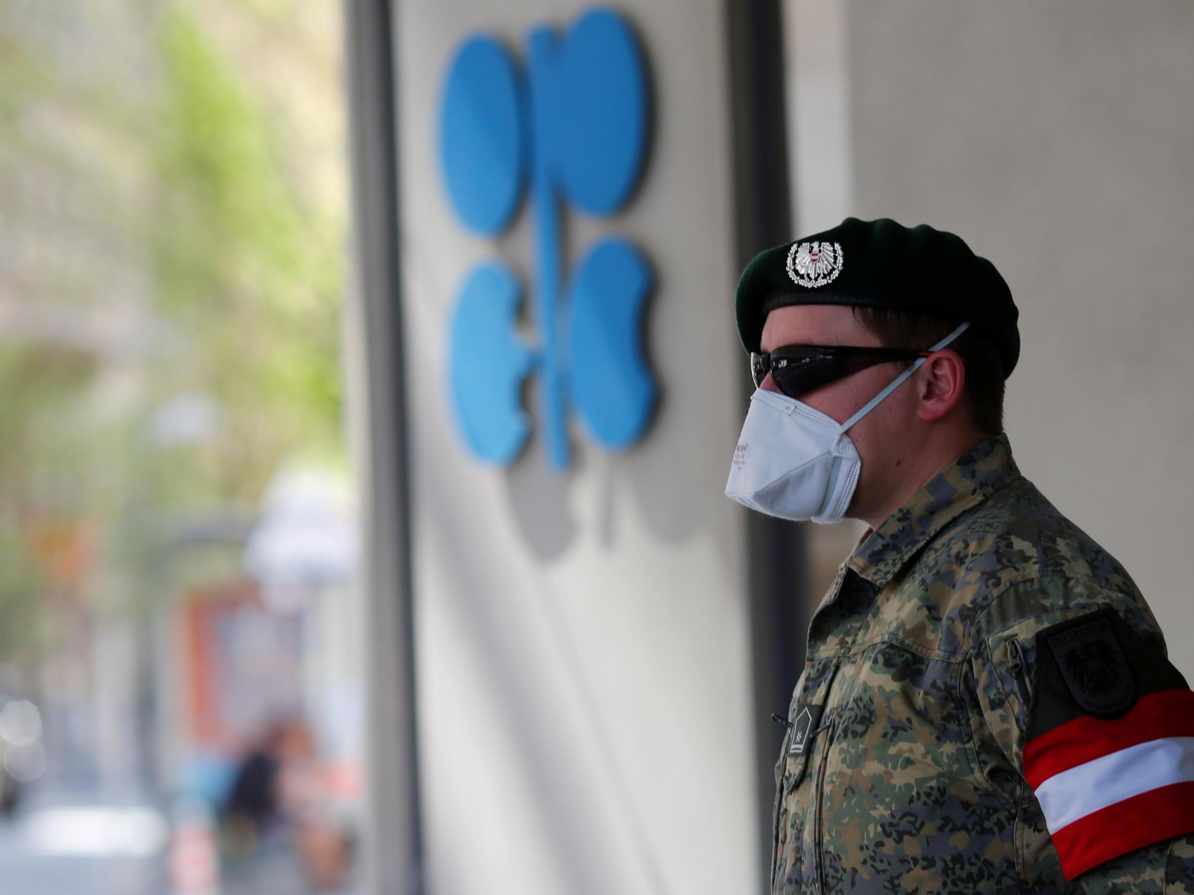 An Austrian army member stands next to the logo of the Organization of the Petroleoum Exporting Countries (OPEC) in front of OPEC's headquarters in Vienna