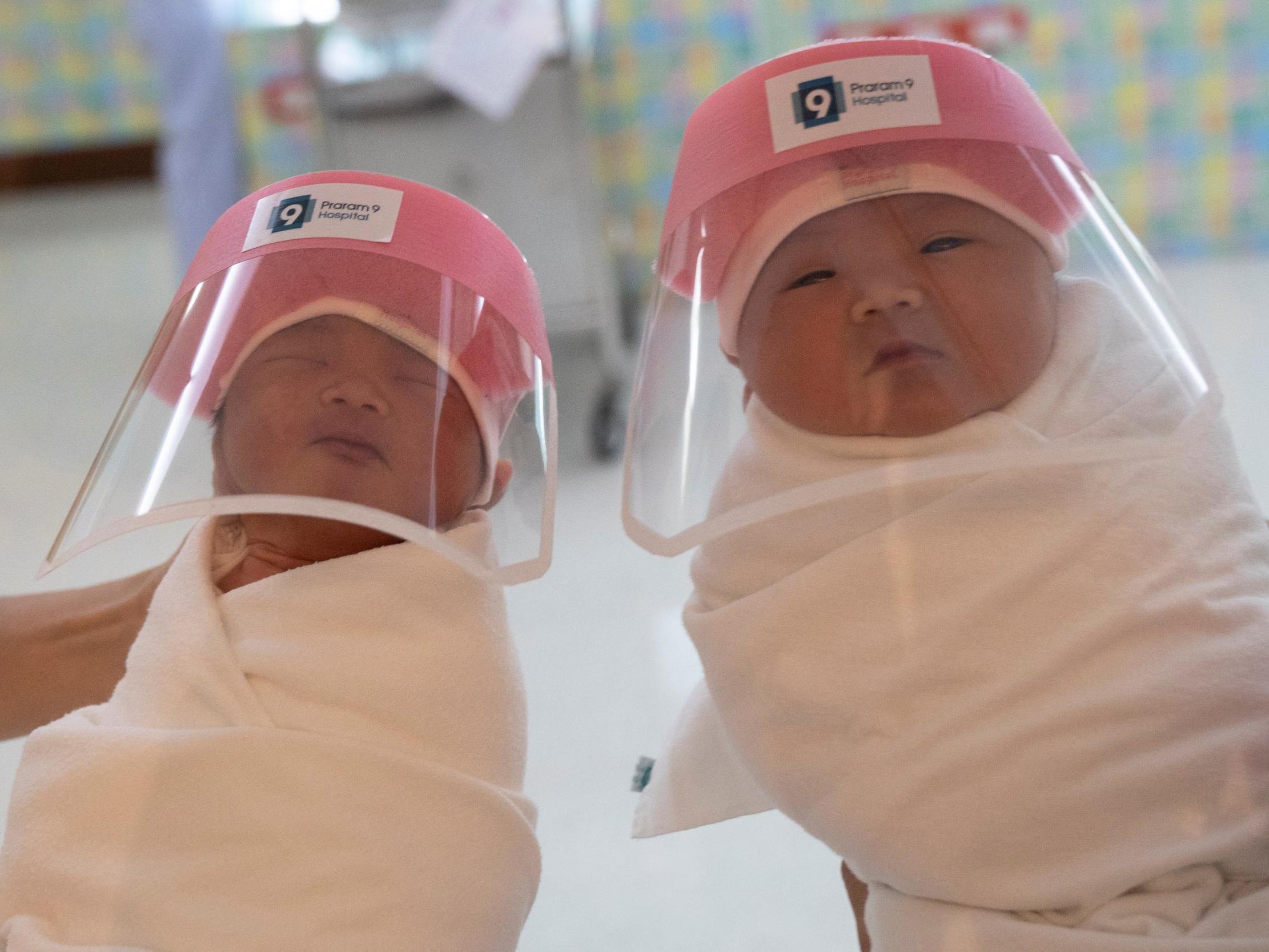 New born baby wearing a tiny face shield in Bangkok - Anadolu Ajansı