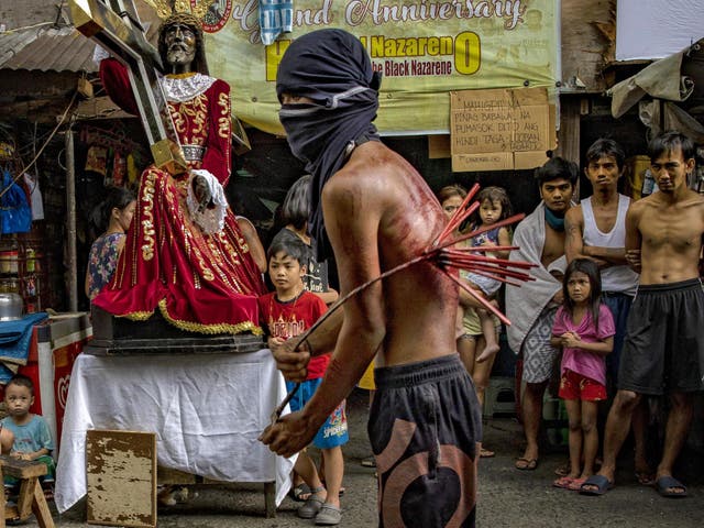 A worshipper whips his bloodied back along a street as penance, defying government orders to avoid religious gatherings and stay home to curb the spread of the coronavirus