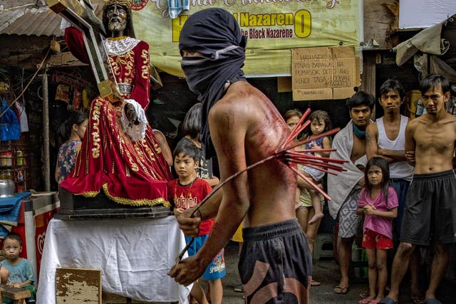A worshipper whips his bloodied back along a street as penance, defying government orders to avoid religious gatherings and stay home to curb the spread of the coronavirus