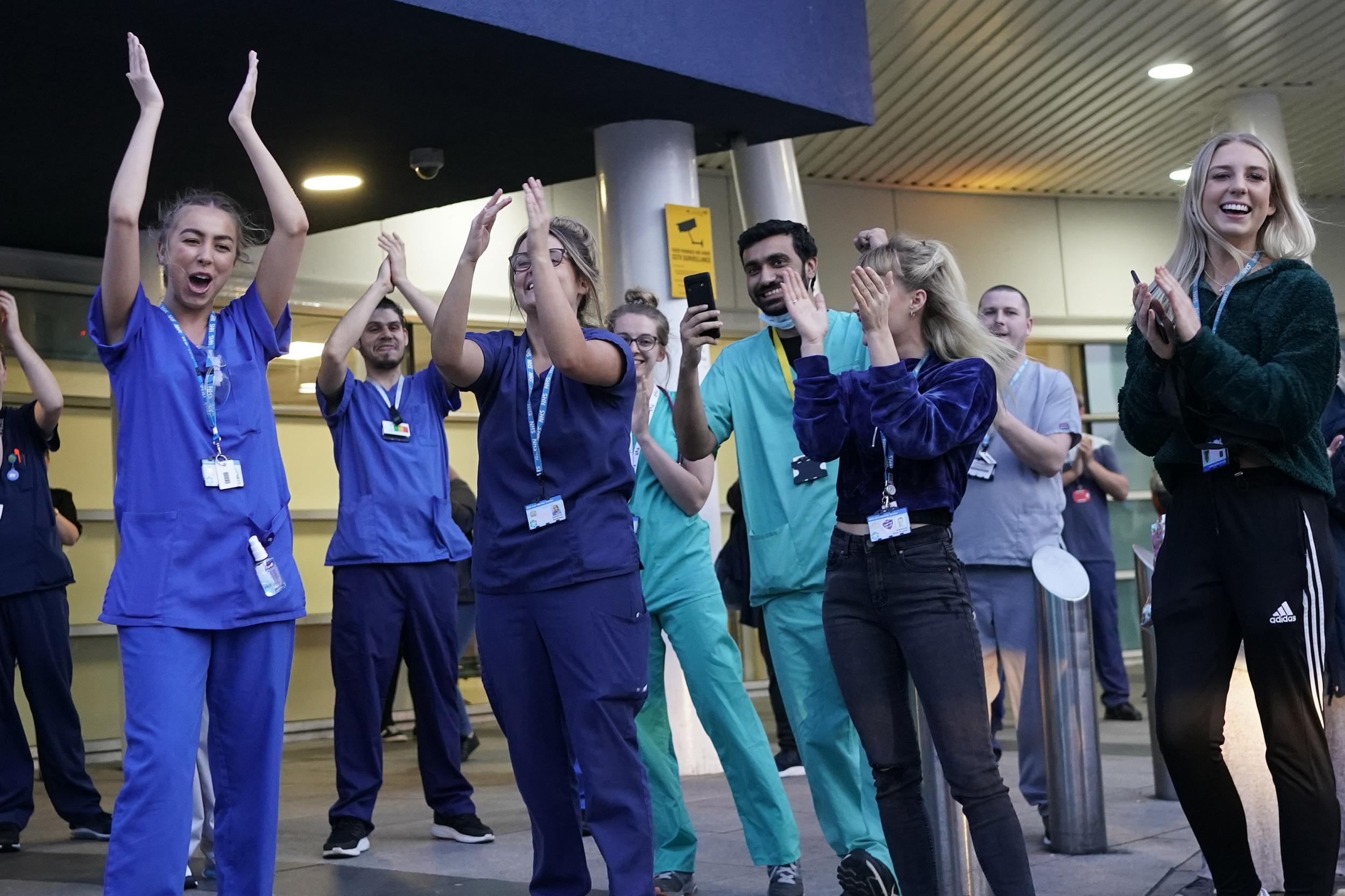 NHS staff applaud themselves and their colleagues at the entrance of the Royal Liverpool Hospital on Thursday