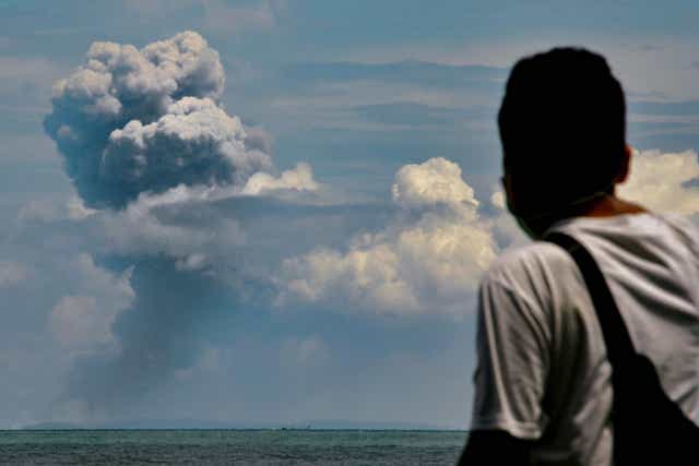 Man watches Krakatau spewing ash during an eruption on Saturday