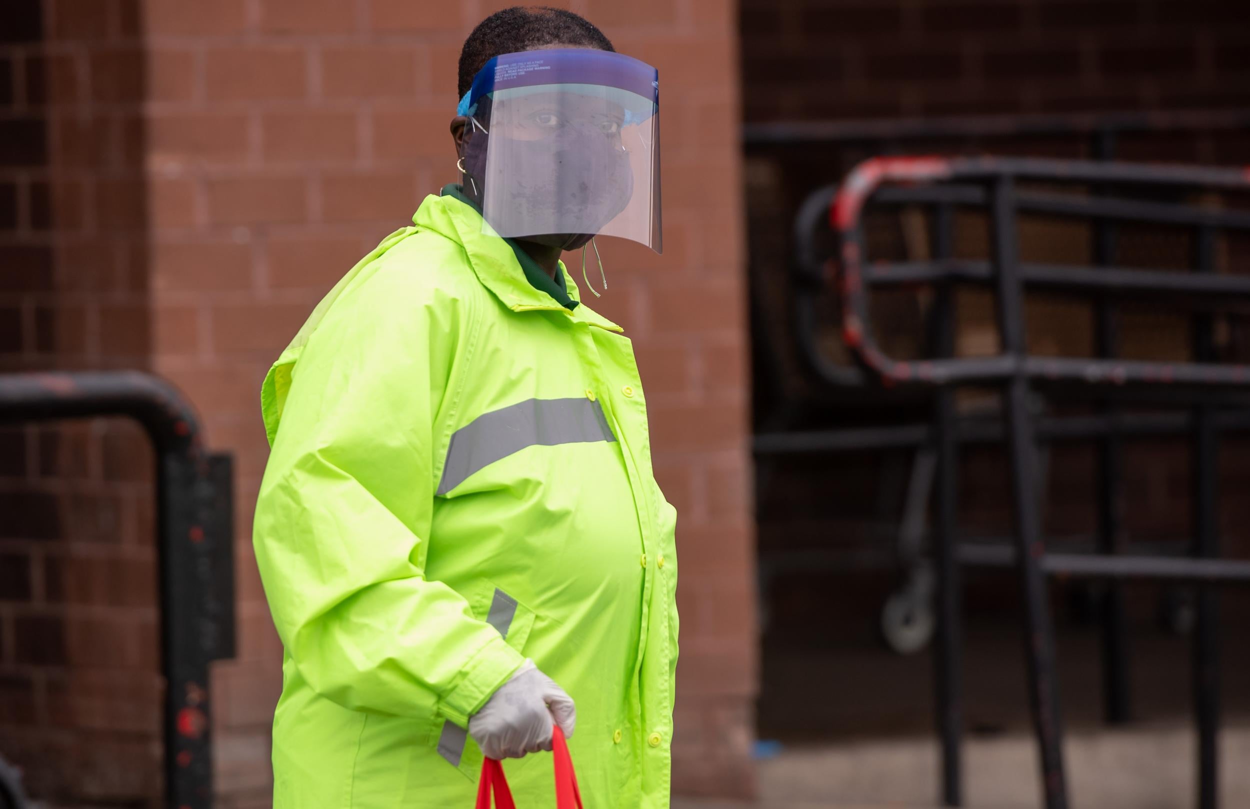 A woman wearing a mask to try and prevent the spread of Covid-19 leaves a supermarket in Washington